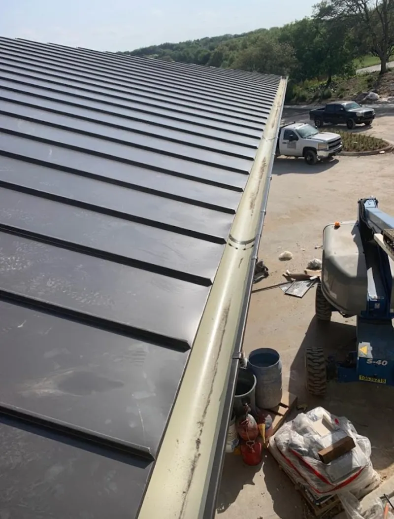 Standing seam panel and gutter detail on a metal roofing jobsite in Somerset
